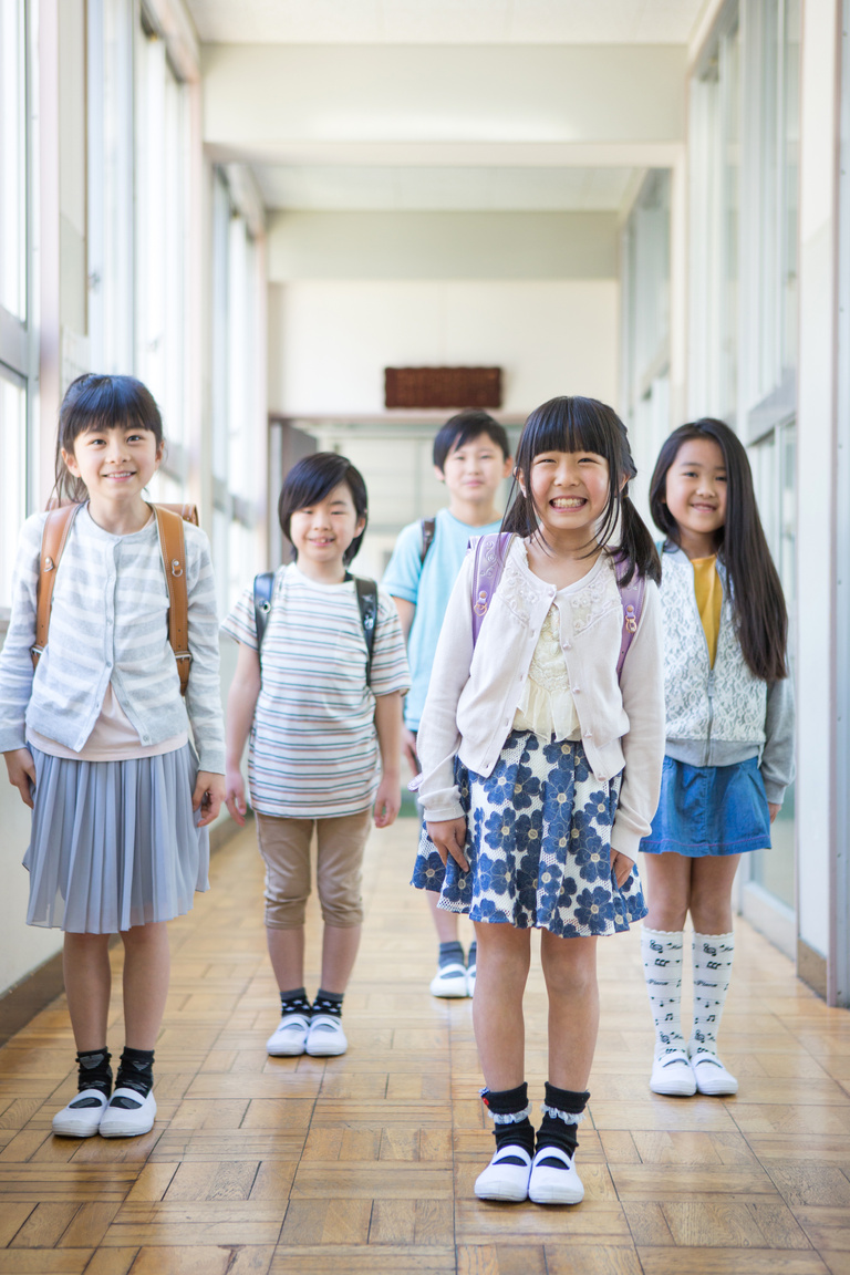 Elementary school children carrying bag