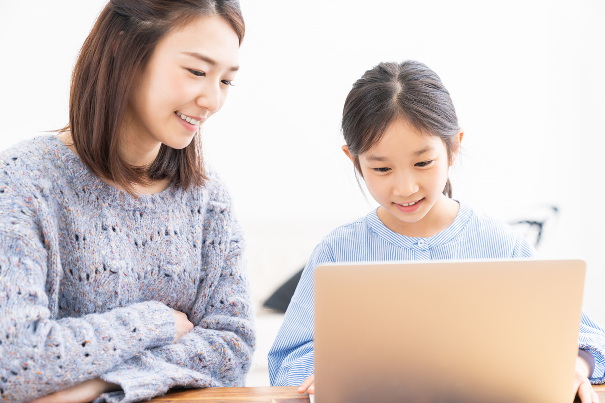 asian mother and daughter,laptop computer,